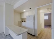 Thumbnail 6 of 19 - Kitchen with White Refrigerator at Ambassador West Apartments, Phoenix, AZ, 85003