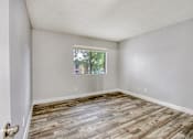 Thumbnail 9 of 26 - A room with wooden flooring and a window.