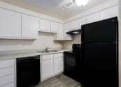 Thumbnail 2 of 21 - a kitchen with black appliances and white cabinets