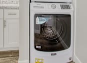 Thumbnail 8 of 26 - A white dishwasher is stacked on top of a white microwave in a kitchen.