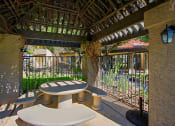 Thumbnail 27 of 32 - a patio with a table and chairs and a fence