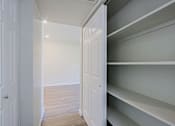 Thumbnail 7 of 15 - A white door is open to a room with shelves.