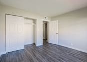 Thumbnail 9 of 15 - A room with a white door and a white wall.