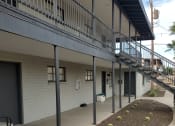 Thumbnail 11 of 13 - an outside view of a building with stairs and plants