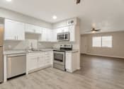 Thumbnail 2 of 9 - an empty kitchen with white cabinets and stainless steel appliances