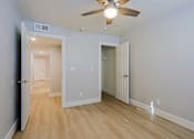 Thumbnail 6 of 13 - an empty room with a ceiling fan and a door to a closet