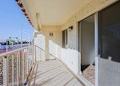 Thumbnail 14 of 25 - A balcony with a railing and a view of the street below.