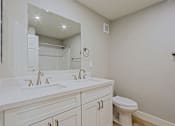 Thumbnail 4 of 13 - a bathroom with a large mirror and a sink and a toilet