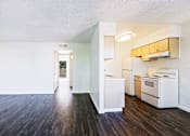 Thumbnail 8 of 25 - A kitchen with white appliances and wooden floors.