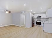 Thumbnail 1 of 13 - a renovated kitchen with white cabinets and stainless steel appliances