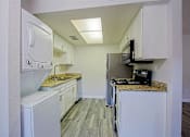 Thumbnail 1 of 14 - A kitchen with white appliances and cabinets at Aspire Mesa, Mesa.