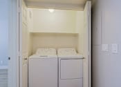 Thumbnail 3 of 13 - a washer and dryer in a laundry room with white walls