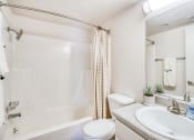 Thumbnail 10 of 27 - a bathroom with a sink toilet and a shower