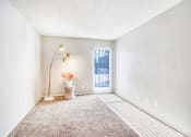 Thumbnail 7 of 27 - an empty room with carpet and a door to a balcony