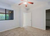 Thumbnail 7 of 23 - an empty room with a ceiling fan and a window