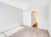 Thumbnail 8 of 27 - a spacious living room with carpet and a hallway to a bedroom