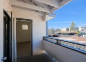 Thumbnail 18 of 21 - a balcony with a door and a view of the city