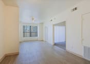 Thumbnail 9 of 21 - the living room and dining room of an apartment with wood flooring