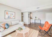 Thumbnail 5 of 27 - a living room with a couch and a coffee table