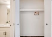 Thumbnail 9 of 27 - a bathroom with a sink and a mirror and an open door