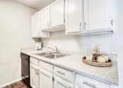 Thumbnail 3 of 27 - the preserve at ballantyne commons apartment kitchen with sink and white cabinets