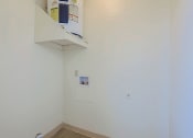 Thumbnail 12 of 21 - an empty room with a white wall and a shelf on the wall
