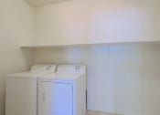 Thumbnail 4 of 23 - an empty laundry room with a washer and dryer in it