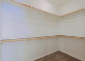 Thumbnail 12 of 23 - an empty room with a white wall and a wooden rail in the corner