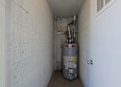 Thumbnail 15 of 25 - A silver metal container with red and yellow labels is in a white hallway.