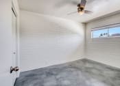 Thumbnail 9 of 10 - an empty room with a ceiling fan and a window