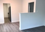 Thumbnail 13 of 13 - an empty living room with a blue wall and wood floors