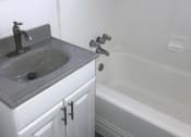 Thumbnail 11 of 13 - a bathroom with a sink and a bath tub