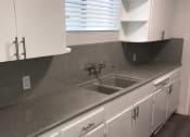 Thumbnail 9 of 13 - a kitchen with white cabinets and a sink