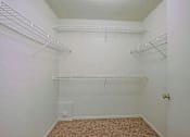 Thumbnail 8 of 17 - Empty room with white walls and shelves.