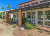 Thumbnail 3 of 19 - the front of a building with plants and rocks in front of it at Tides on Southern, Arizona