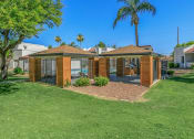 Thumbnail 5 of 19 - a small house with a gated yard and a palm tree at Tides on Southern, Mesa