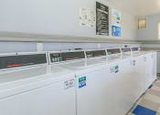Thumbnail 8 of 19 - a row of washers and dryers in a laundry room at Tides on Southern, Arizona, 85204