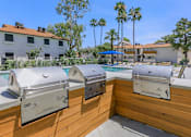 Thumbnail 28 of 28 - Stainless steel BBQ grill area with 3 grills by the pool at Tides on McDowell, Phoenix