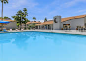Thumbnail 26 of 28 - the swimming pool in front of resident clubhouse with moon metal work on chimney  at Tides on McDowell, Phoenix, 85035