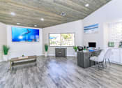 Thumbnail 20 of 28 - A modern leasing clubhouse with a wooden ceiling and grey flooring at Tides on McDowell, Phoenix, Arizona 85035