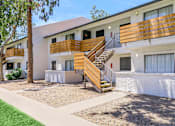 Thumbnail 16 of 28 - A white building with a wooden staircase in front at Tides on McDowell, Phoenix, AZ