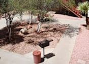 Thumbnail 5 of 5 - A red mailbox sits on a sidewalk in front of a building with a red staircase at Ambassador West Apartments, Phoenix, AZ