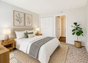 Thumbnail 13 of 28 - A bedroom with a large bed, a nightstand, and a plant.