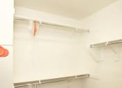 Thumbnail 8 of 14 - a white closet with shoes and hangers in it
