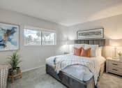 Thumbnail 9 of 24 - a bedroom with a bed and two windows