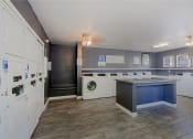 Thumbnail 30 of 32 - a laundry room with washer and dryer and a counter with a washing machine