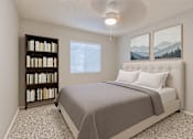Thumbnail 15 of 24 - A bedroom with a bed, bookshelf, and two pictures on the wall at Connect on Northern, Glendale, AZ 85301
