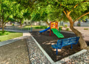 Thumbnail 12 of 13 - a playground with a blue bench and a colorful slide at Connect on Northern, Arizona