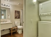 Thumbnail 4 of 13 - a bathroom with a toilet and a sink and a washer and dryer at Connect on Northern, Arizona, 85301