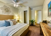 Thumbnail 5 of 13 - a bedroom with a large bed and a ceiling fan at Connect on Northern, Glendale Arizona